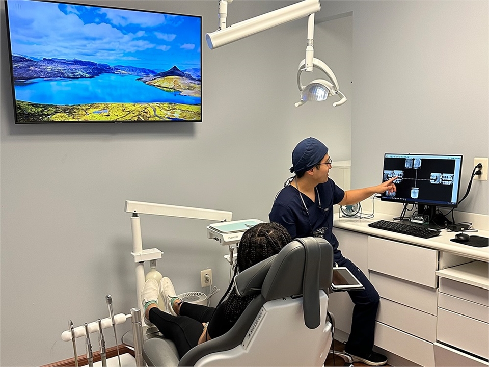 Germantown Dr. Sang Cho explaining dental implants procedure to patient at New Life Dental