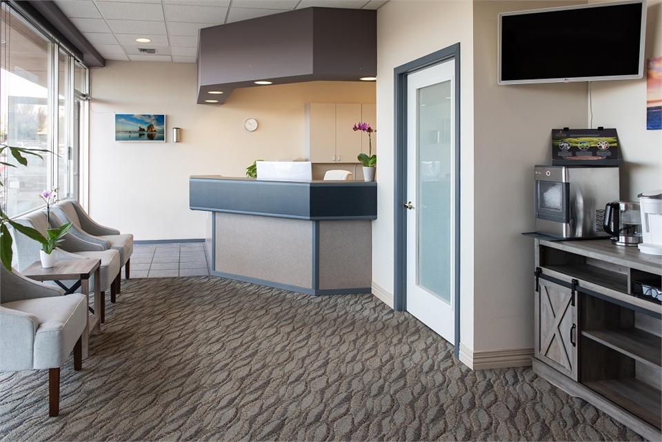 Waiting room front desk and refreshment station at Serenity Dental Spokane Valley