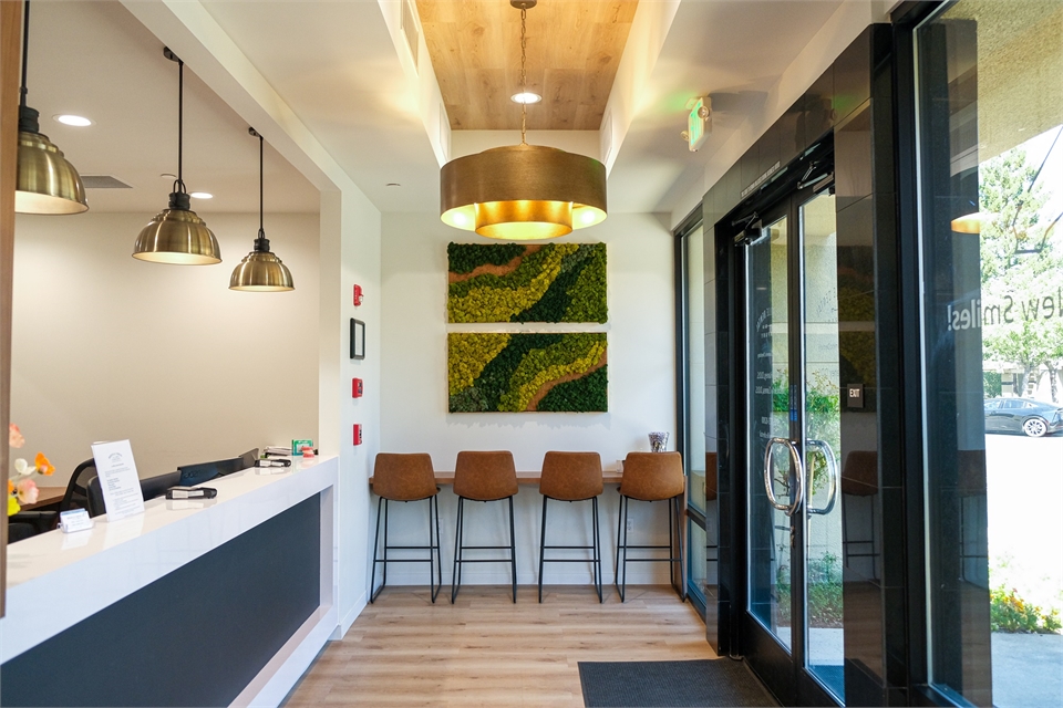 Front desk reception area and entrance door at Roseville Dental Company