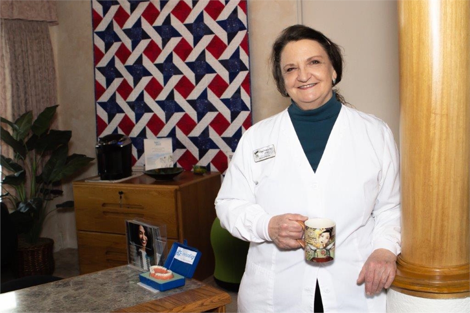 Dr. Virginia McMillan standing at front desk at John Day Smiles  