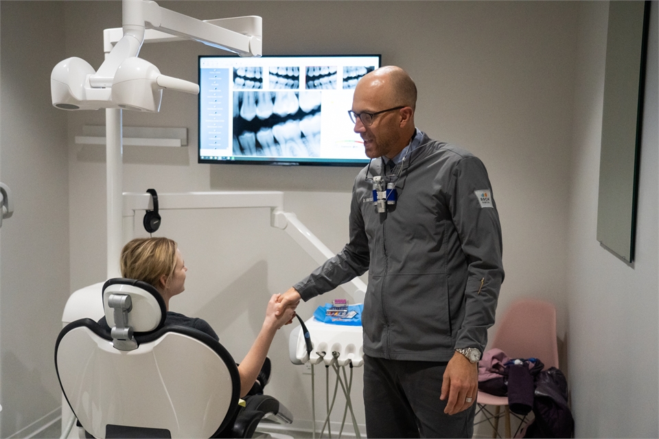 Fargo ND Dentist Dr. Derek Harnish of Arch Dental working wih Patient