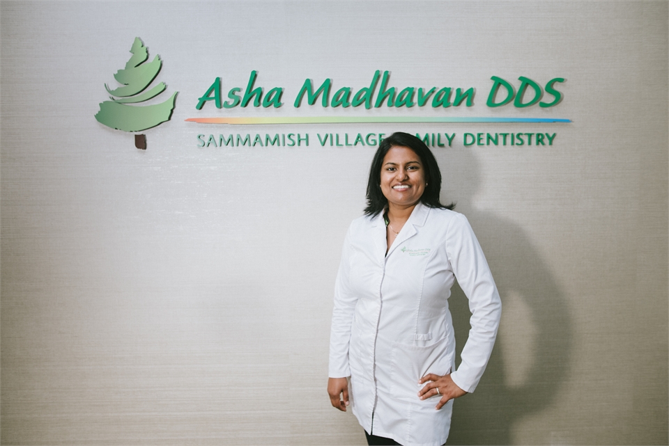Sammamish WA dentist Asha Madhavan DDS in front of sign