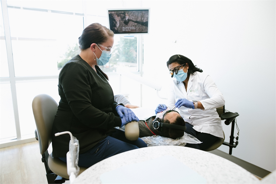 Sammamish WA dentist Asha Madhavan DDS performing dental implants at his clinic