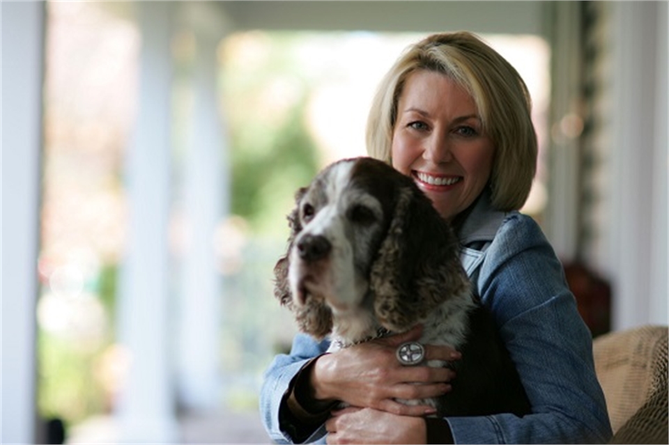 Smiling patient Kathy with her dog at The Gorman Center for Fine Dentistry North Oaks dentist