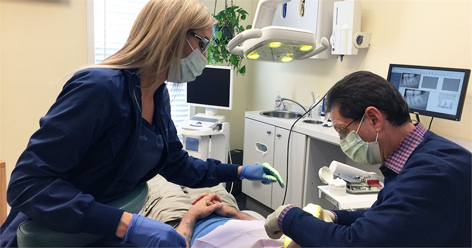 Waldorf dentist Dr. Paul B Silberman and his dental assistant working with a patient at The Silberma