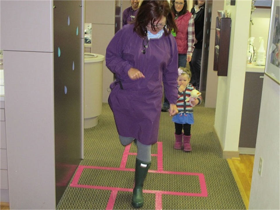 Seattle dentist Dr fidler playing hop scotch on kids day at Fidler On The Tooth