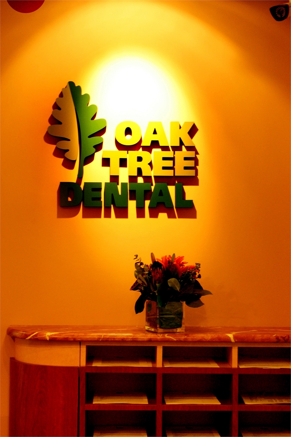 Oak Tree Dental logo on the main wall facing entrance