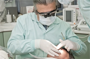 Dentist working on a patient with magnifying loupes