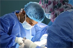 Surgeon in action - working on a patient