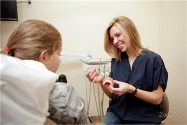 Dentist at Union Square Dental explaining clear braces procedure to pediatric patient
