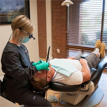 Dental hygienist prepares patient for periodontal treatment at Torghele dentistry