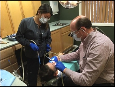 Glenmont NY dentist Dr. Michael V Conte  DDS performing dental treatment at Glenmont Dental