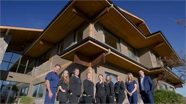 Dental team at Cascade Dental Care South Hill against the backdrop of the office building