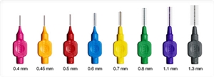 Different colors and sizes interdental brushes - pink 0.4 mm, dark yellow 0.45 mm, red 0.5 mm, blue 0.6 mm, light yellow 0.7 mm, green 0.8 mm, purple 1.1 mm, black 1.3 mm