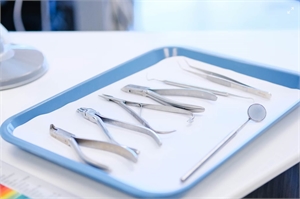 Stainless steel dental surgery intruments arranged on dental tray