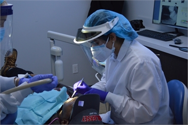 Elizabeth dentist Dr. Nayak working on dentures patient at Banker Dental Associates