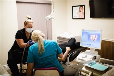 Dental assistants at work with root canal patient at Winter Park Dental