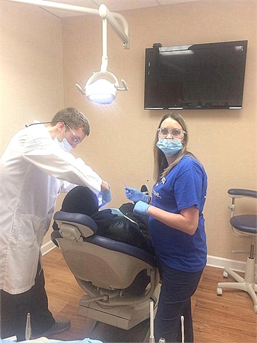 Justin Neibauer performing root canal procedure at his dental clinic in Fredericksburg VA 22407