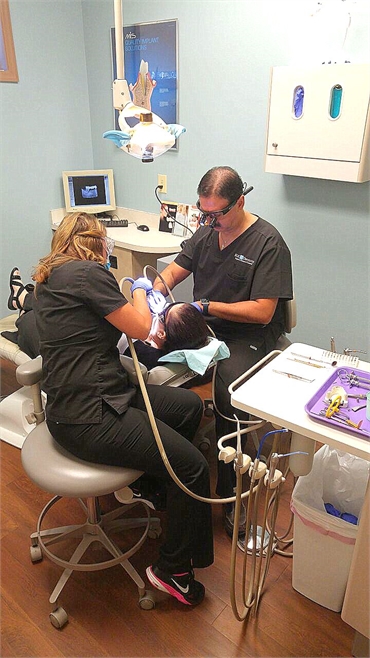 Dr. Tadros performing LANAP procedure in his Largo dentistry office