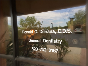 signage on window pane outside our dentistry office in Tucson AZ just a few miles away from The Hill