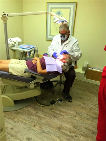 Dr. Deriana performing periodontal procedure in his dental clinic in Tucson AZ