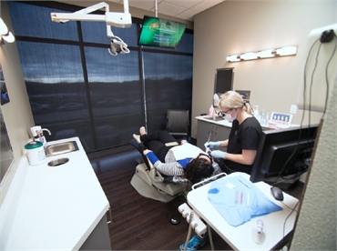 Dental hygienist at work at dental veneer center Gordon Dental Kansas City MO 64151