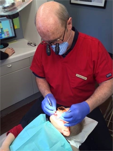 Dr. Stephen Allen performing dental procedure