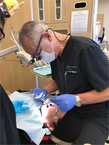 Burke dentist Dr. Alex McMillan performing dental treatment at Burke Centre Dental Arts