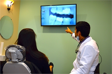 Dallas dentist Dr. Ron Hassanzadeh explaining dental implants