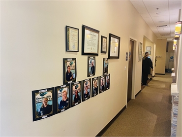 Accreditions display wall side view and hallway at Seven Hills Dentistry Dallas GA