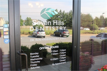 Office hours and signage on the glasspane of entrance door at Seven Hills Dentistry Dallas GA