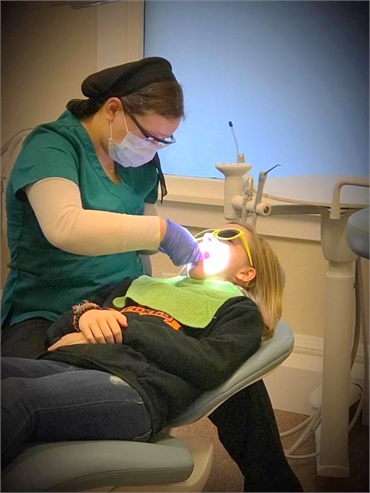 Dental hygienist at work at Acorn Dentistry for Kids in Silverton OR