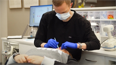 Spokane Valley orthodontist Dr. Kirk Bean working on Invisalign procedure at Dr. C Orthodontics