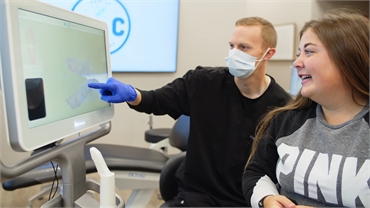 Spokane Valley dentist Dr. Kirk Bean explaining ceramic braces to patient