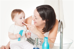 When do I start brushing my baby's teeth?