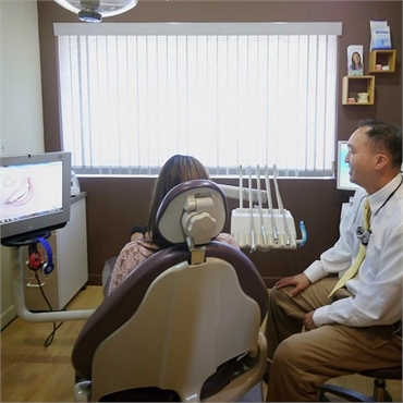 Dr. Timothy Shen talking to his patient about Dental implant options