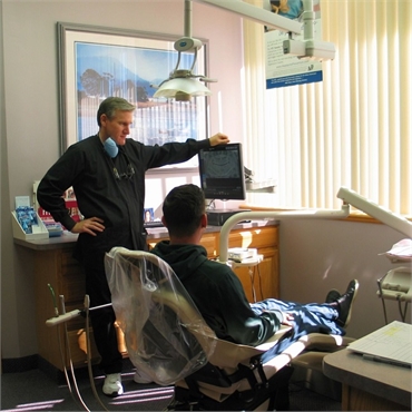 Clinton Township dentist Dr. Michael Aiello explaining LANAP periodontal treatment to patient