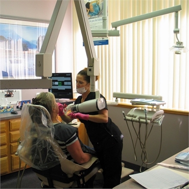 Dental hygienist preparing patient for root canal treatment