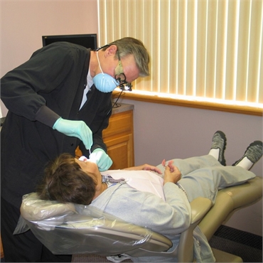 Dr. Michael Aiello performing dental imlant procedure at his clinic in Clinton Township