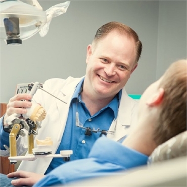 Spokane Prosthodontist Dr. Molgard sharing lighter moments with patient