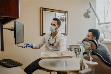 Dr. Alon Bekerman DMD explaining dental crown options to patient at Premiere Dental of Abington