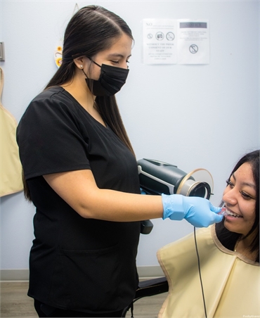 Dental hygienist takes x-ray of root canal patient at Dallas dentist Dulce Dental