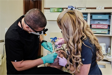 Miami dentist Dr Gio Gonzalez performing root canal procedure at Flossy Smiles