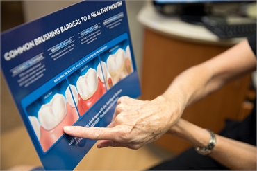 Dental hygienist explaining good oral habits at Clearwater Dental Associates