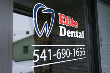 Signage on glass panel at Medford dentist Elite Dental