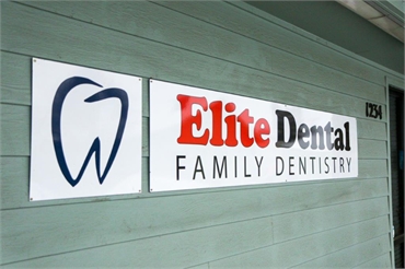 Signage on glass panel at Medford dental implants expert Elite Dental