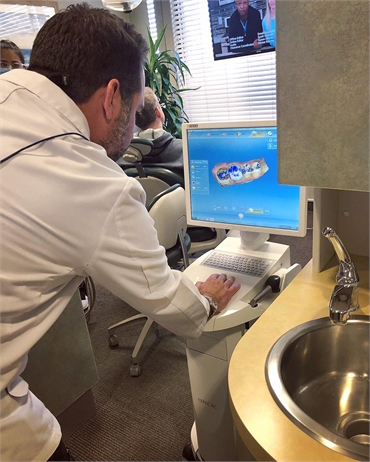 Las Vegas dentist Dr. Richard Racanelli working on Sirona CEREC intraoral scanner for dental crowns