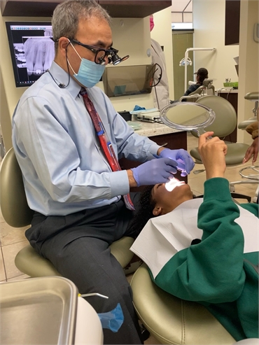 Concord dentist Dr. Haidari performing dental implants procedure at Clayton Dental Group