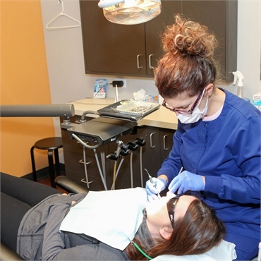 Dental hygienist at Lincoln Center Dental with root canal patient