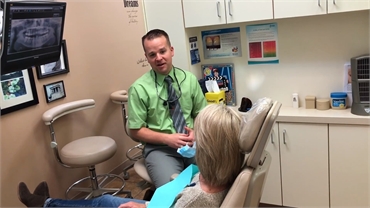 Centennial dentist Dr. Bassett explaining options in cosmetic dentistry at Ridgeview Dental